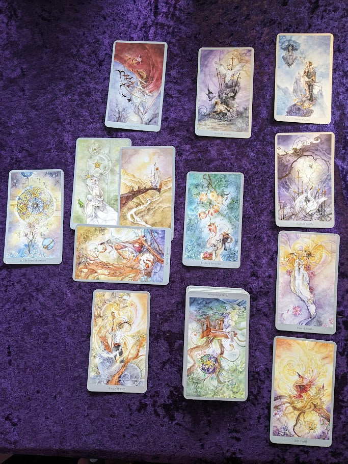 Tarot card spread featuring Celtic Cross  spread with clarification and karma cards added. Artwork of cards is by Stephanie Law and features watercolor art that is highly detailed 